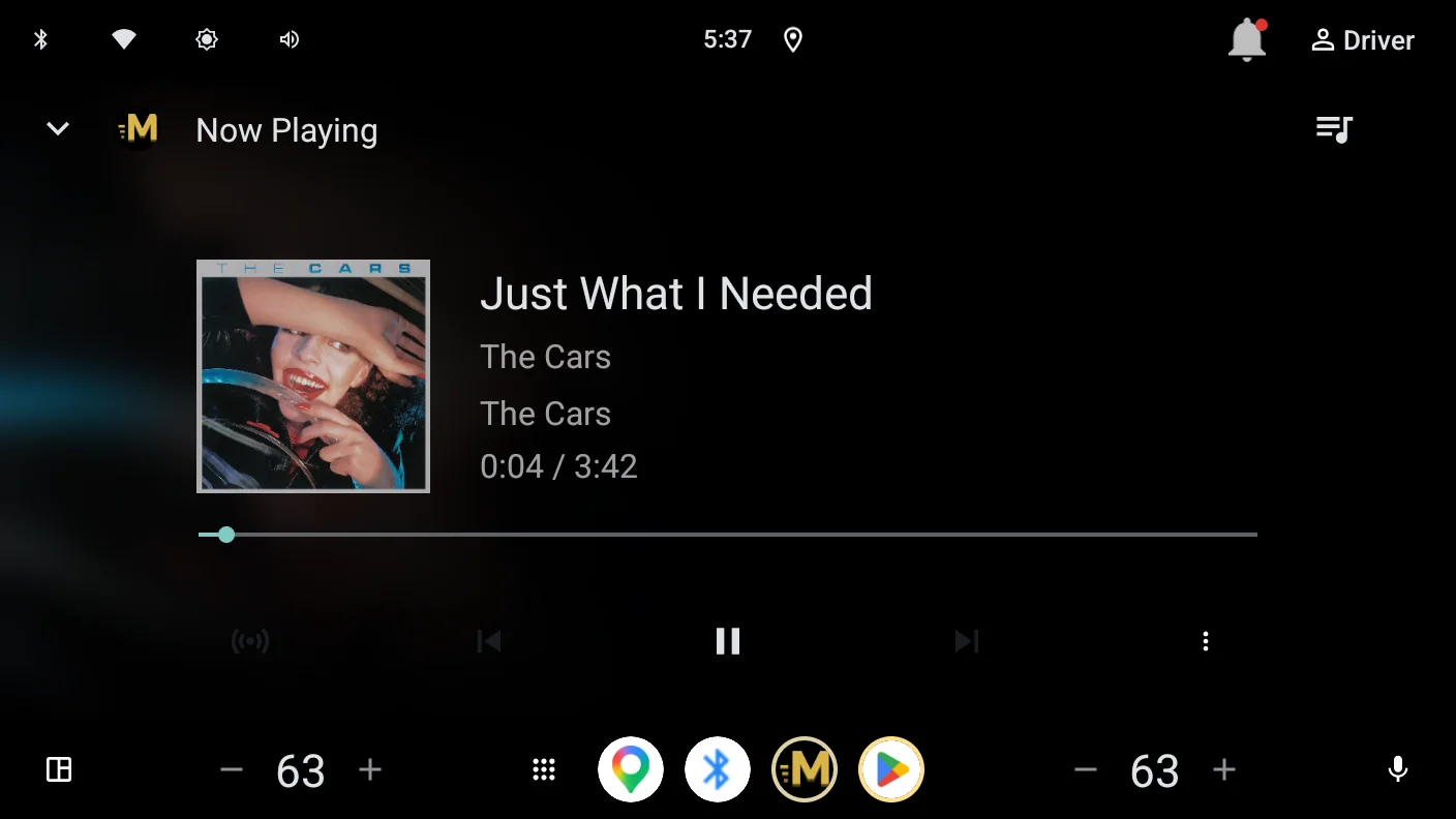 Momentum's Now Playing screen on an Android Automotive display: album art, track title, and playback controls